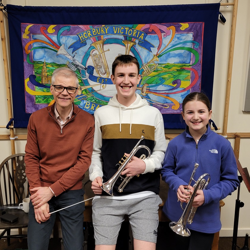 Will and Faye receiving their new instruments from youth conductor Michael Dodd